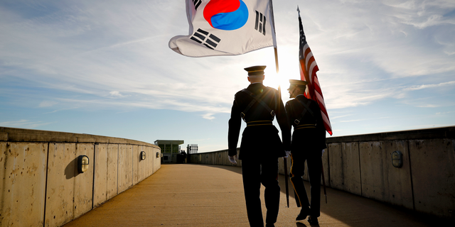 Members of the Honor Guard carry U.S. and South Korea flags after participating in the 2018 Security Consultative at the Pentagon, co-hosted by Defense Secretary Jim Mattis and South Korea Minister of Defense Jeong Kyeong-doo, Wednesday, Oct. 31, 2018. (AP Photo/Pablo Martinez Monsivais)