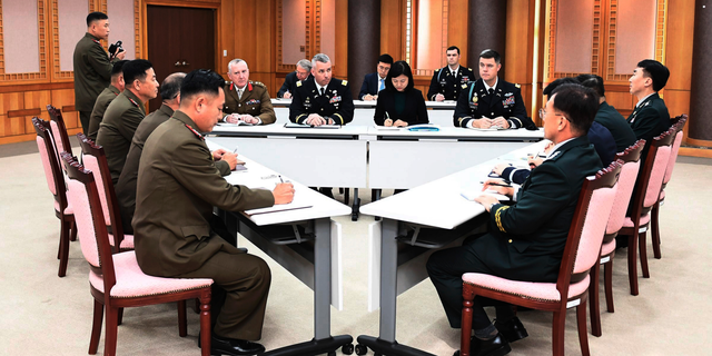 FILE - In this Oct. 16, 2018, file photo provided by South Korea Defense Ministry, the U.S.-led United Nations Command, center, South Korean and North Korean, left, military officers attend a meeting at the southern side of Panmunjom in the Demilitarized Zone, South Korea. The two Koreas and the U.S.-led U.N. Command on Monday, Oct. 22, 2018, are meeting again at the Koreas' border village to examine an ongoing effort to disarm the area. (South Korea Defense Ministry via AP, File)