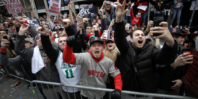 Boston Red Sox fans cheer during a parade to celebrate the team's World Series championship over the Los Angeles Dodgers, Wednesday, Oct. 31, 2018, in Boston. (AP Photo/Charles Krupa)