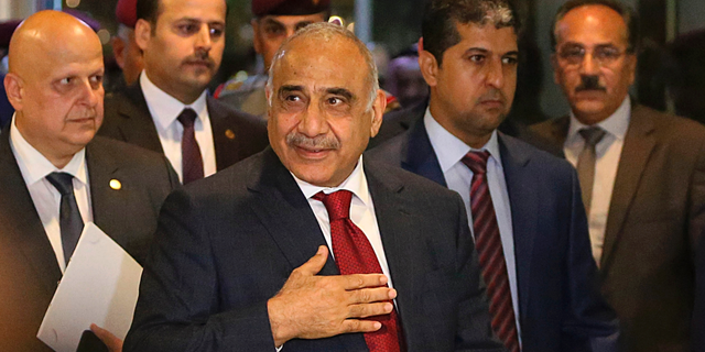Prime Minister-designate Adel Abdul-Mahdi, center, arrives to the parliament building, in the heavily guarded Green Zone, in Baghdad, Iraq, Wednesday, Oct. 24, 2018. Iraq's parliament is convening to vote on Prime Minister-designate Adel Abdul-Mahdi's ministry appointments, and the parliament must confirm the appointments for the government to be sworn in. (AP Photo/Hadi Mizban)