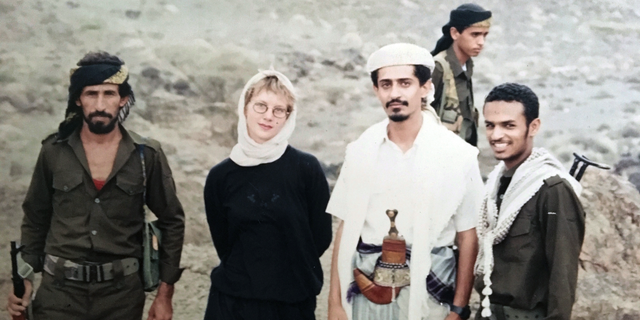 This 1994 photo provided by Katherine Roth shows her standing with Yemeni fighters. The photo was taken by Jamal Khashoggi in Yemen after the country’s civil war. Khashoggi was Roth’s friend and mentor when she was a young reporter on a fellowship studying Islamic movements. (Jamal Khashoggi/Courtesy of Katherine Roth via AP)