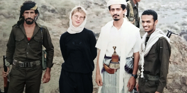 This 1994 photo provided by Katherine Roth shows her standing with Yemeni fighters. The photo was taken by Jamal Khashoggi in Yemen after the country’s civil war. Khashoggi was Roth’s friend and mentor when she was a young reporter on a fellowship studying Islamic movements. (Jamal Khashoggi/Courtesy of Katherine Roth via AP)