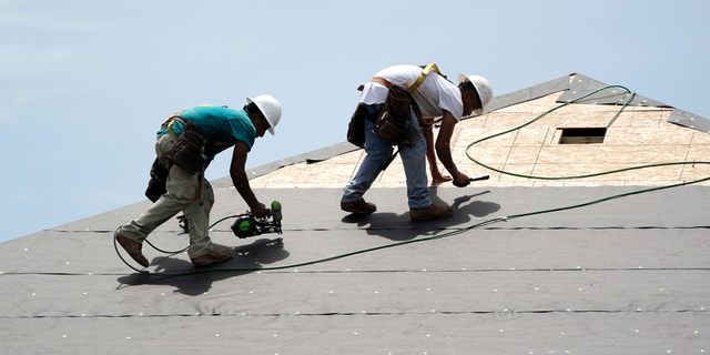 FILE- In this July 23, 2018, file photo construction workers put down roofing paper on home in Houston. General contractors and other small businesses in the home remodeling industry can expect revenue to slow in 2019, the result of rising mortgage rates and sluggish home sales. That's the prediction of Harvard University's Joint Center for Housing Studies, which last week issued its quarterly report on home remodeling. (AP Photo/David J. Phillip, File)