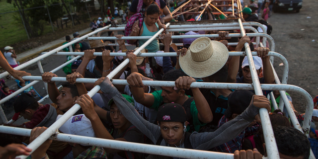 Migrants travel on a cattle truck, as a thousands-strong caravan of Central American migrants slowly makes its way toward the U.S. border, between Pijijiapan and Arriaga, Mexico, Friday, Oct. 26, 2018. Many migrants said they felt safer traveling and sleeping with several thousand strangers in unknown towns than hiring a smuggler or trying to make the trip alone. (AP Photo/Rodrigo Abd)