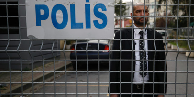 A security guard stands behind barriers blocking the road leading to Saudi Arabia's consulate in Istanbul, Saturday, Oct. 20, 2018. Turkey will "never allow a cover-up" of the killing of Saudi journalist Jamal Khashoggi in Saudi Arabia's consulate in Istanbul, a senior official in Turkey's ruling party said Saturday after Saudi Arabia announced hours earlier that the writer died during a "fistfight" in its consulate. (AP Photo/Emrah Gurel)