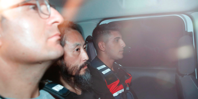 Japanese journalist Jumpei Yasuda, center, is driven out of the immigration center in Antakya, Turkey, Wednesday, Oct. 24, 2018. Yasuda was freed after more than three years of captivity in Syria Wednesday. (Yosuke Mizuno/Kyodo News via AP)