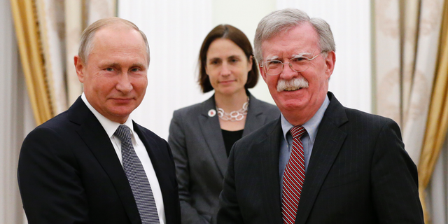 Russian President Vladimir Putin, left, shakes hands with U.S. National security adviser John Bolton during their meeting in the Kremlin in Moscow, Russia, Tuesday, Oct. 23, 2018. (AP Photo/Alexander Zemlianichenko)