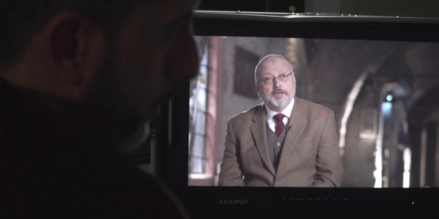 In this image made from an Oct. 18, 2018, video provided by Metafora Production, Eiad Alhaji, left, edits video in his studio as Jamal Khashoggi on a monitor speaks during an interview held in March 2018 at an undisclosed location. Eighteen days after Khashoggi disappeared, Saudi Arabia acknowledged early Saturday, Oct. 20, 2018, that the 59-year-old writer has died in what it said was a "fistfight" inside the Saudi consulate in Istanbul. (Metafora Production via AP)