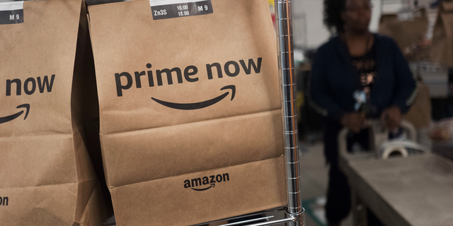 FILE- In this Dec. 20, 2017, file photo, Prime Now customer orders are ready for delivery at the Amazon warehouse in New York. Same-day delivery promises the convenience of online ordering with nearly the same immediacy of store buying. (AP Photo/Mark Lennihan, File)