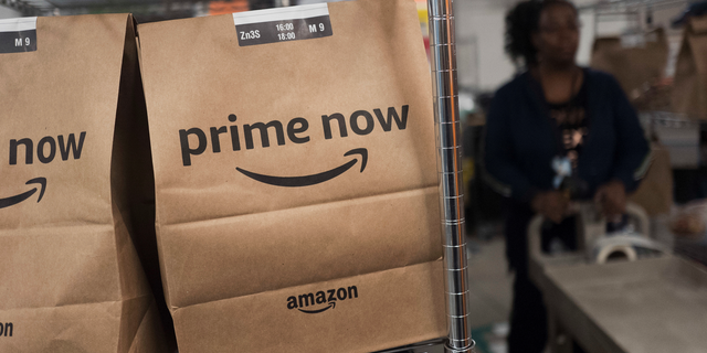 FILE- In this Dec. 20, 2017, file photo, Prime Now customer orders are ready for delivery at the Amazon warehouse in New York. Same-day delivery promises the convenience of online ordering with nearly the same immediacy of store buying. (AP Photo/Mark Lennihan, File)