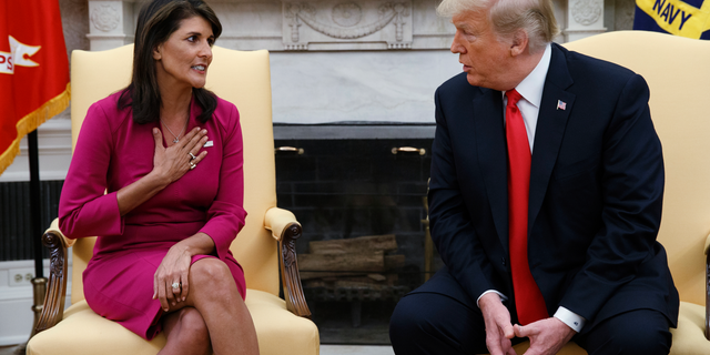 President Donald Trump meets with outgoing U.S. Ambassador to the United Nations Nikki Haley in the Oval Office of the White House, Tuesday, Oct. 9, 2018, in Washington.