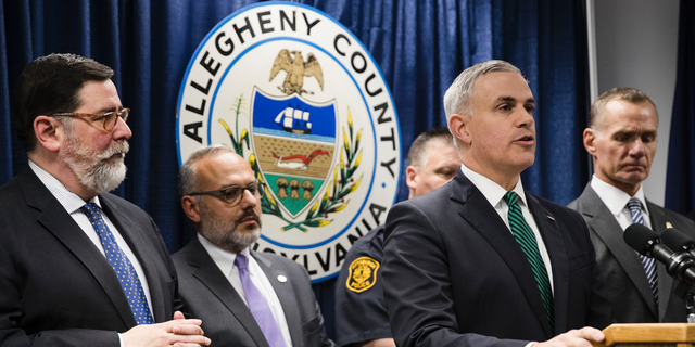 United States Attorney Scott Brady, at podium, speaks with members of the media during a news conference in the aftermath of a deadly shooting at the Tree of Life Synagogue in Pittsburgh, Sunday, Oct. 28, 2018. (AP Photo/Matt Rourke)