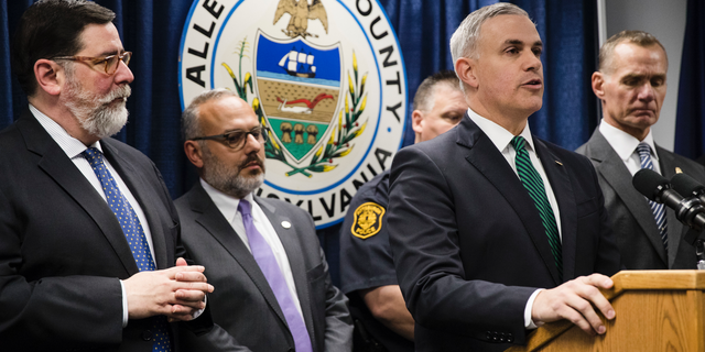 United States Attorney Scott Brady, at podium, speaks with members of the media during a news conference in the aftermath of a deadly shooting at the Tree of Life Synagogue in Pittsburgh, Sunday, Oct. 28, 2018. (AP Photo/Matt Rourke)