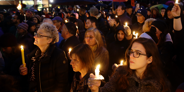 People hold candles as they gather for a vigil in the aftermath of a deadly shooting at the Tree of Life Congregation, in the Squirrel Hill neighborhood of Pittsburgh, Saturday, Oct. 27, 2018. (AP Photo/Matt Rourke)