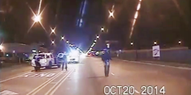 In this Oct. 20, 2014 file image taken from dash-cam video provided by the Chicago Police Department, Laquan McDonald, right, walks down the street moments before being fatally shot by Chicago Police officer Jason Van Dyke in Chicago. (Chicago Police Department via AP, File)