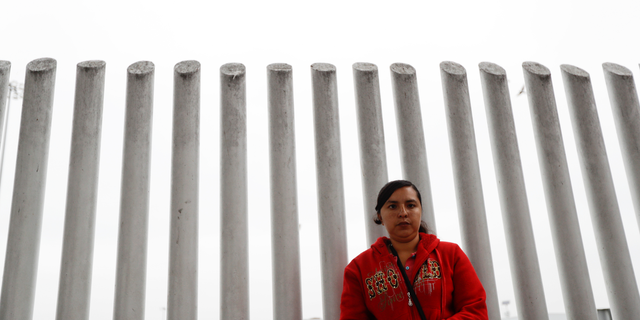 In this Oct. 23, 2018 image, Ana Delia Soto Duarte, who seeks asylum in the United States from her home in Guerrero, Mexico, waits in hopes of hearing her number called to cross the border in Tijuana, Mexico.