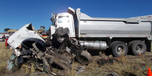This Friday, Oct. 19, 2018 photo provided by the Utah Highway Patrol shows the scene of a head-on collision of a dump truck and a pickup on a state highway near Heber, Utah. State troopers say the dump truck crossed a highway median and collided with the pickup truck traveling in the opposite direction, killing all six men in the pickup in an accident authorities suspect may was caused by alcohol and prescription drugs. The Utah Highway Patrol said Saturday its officers found prescription pills and open containers of alcohol inside the dump truck. (Utah Highway Patrol via AP)