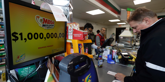 A sign displays the estimated Mega Millions jackpot at a convenience store in Chicago, Friday, Oct. 19, 2018. Friday's jackpot has soared to $1 billion, the second-largest prize in U. S. lottery history. (AP Photo/Nam Y. Huh)