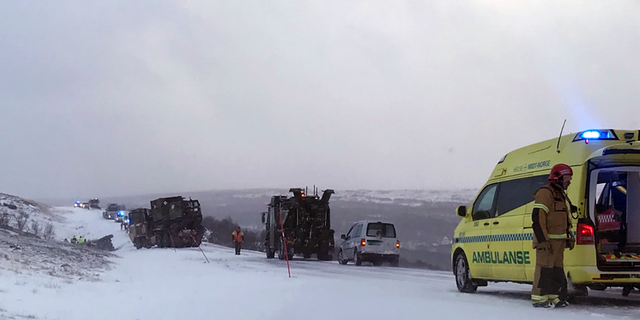 Emergency services attend the scene after four soldiers were injured during the NATO exercise Trident Juncture at Stuggusjoen in Tydal, Norway, Tuesday, Oct. 23, 2018. A report says multiple military vehicles were involved in the accident Tuesday in conjunction with exercise.(Ola Haakon Oestby / NTB scanpix via AP)