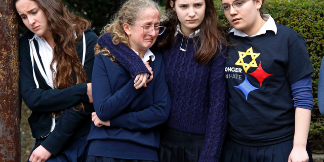 Students from the Yeshiva School in the Squirrel Hill neighborhood of Pittsburgh, pay their respects as the funeral procession for Dr. Jerry Rabinowitz passes their school en route to Homewood Cemetery following a funeral service at the Jewish Community Center, Tuesday Oct. 30, 2018. Rabinowitz was one of people killed while worshipping at the Tree of Life synagogue on Saturday, Oct. 27, 2018. (AP Photo/Gene J. Puskar)