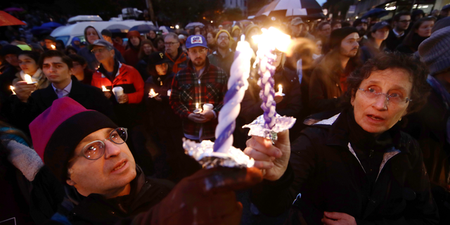 People light candles as they gather for a vigil in the aftermath of a deadly shooting at the Tree of Life Congregation, in the Squirrel Hill neighborhood of Pittsburgh, Saturday, Oct. 27, 2018. (AP Photo/Matt Rourke)