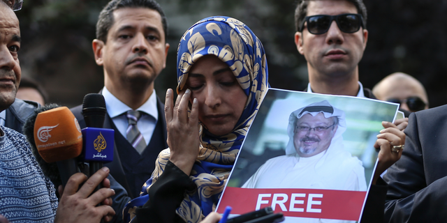 Holding a picture of missing Saudi writer Jamal Khashoggi, Tawakkol Karman, of Yemen the Nobel Peace Prize laureate for 2011, talks to members of the media near the Saudi Arabia consulate in Istanbul, Friday, Oct. 5, 2018.