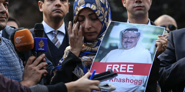 Holding a picture of missing Saudi writer Jamal Khashoggi, Tawakkol Karman, of Yemen the Nobel Peace Prize laureate for 2011, talks to members of the media near the Saudi Arabia consulate in Istanbul, Friday, Oct. 5, 2018.