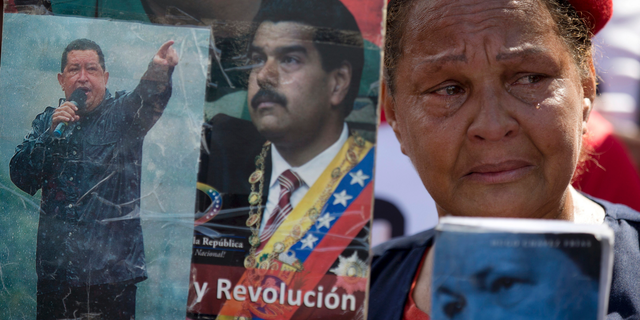 FILE - In this March 15, 2018 file photo, a supporter of Venezuela's late President Hugo Chavez and current President Nicolas Maduro attends a rally marking the fifth anniversary of Chavez's death, in Caracas, Venezuela. A Harvard-trained conflict resolution expert is flying to Caracas to attempt the seemingly impossible: jumpstarting political dialogue in deeply polarized Venezuela. (AP Photo/Fernando Llano)