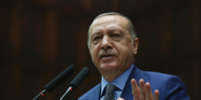 Turkey's President Recep Tayyip Erdogan addresses supporters at the parliament, in Ankara, Tuesday, Oct. 30, 2018.  Erdogan said the Turkish prosecutor repeated to his Saudi counterpart Turkey's extradition request of 18 suspects detained in Saudi Arabia for the Oct. 2 killing to be put on trial in Istanbul. (Presidential Press Service via AP, Pool)