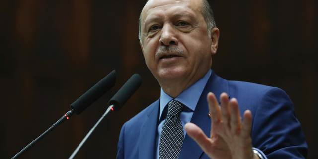 Turkey's President Recep Tayyip Erdogan addresses supporters at the parliament, in Ankara, Tuesday, Oct. 30, 2018. Erdogan said the Turkish prosecutor repeated to his Saudi counterpart Turkey's extradition request of 18 suspects detained in Saudi Arabia for the Oct. 2 killing to be put on trial in Istanbul. (Presidential Press Service via AP, Pool)