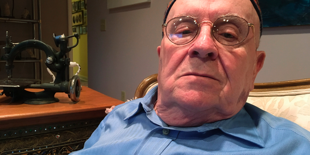 In this Monday, Oct. 29, 2018 photo, Holocaust survivor Judah Samet, 80, sits in his living room in Pittsburgh. Samet survived the infamous Bergen-Belsen concentration camp as a boy, and he was in the parking lot at Tree of Life synagogue Saturday as a gunman rampaged through the halls, killing Samet's fellow congregants. (AP Photo/Allen G. Breed)