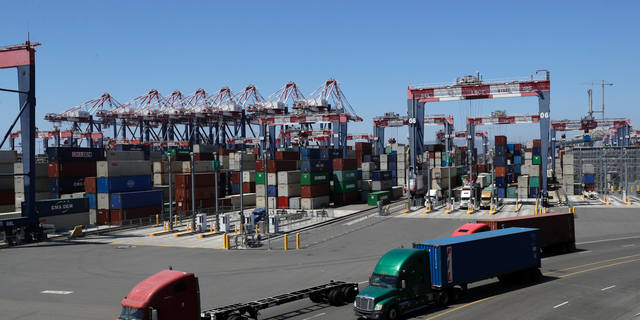 FILE- In this Aug. 22, 2018, file photo trucks travel along a loading dock at the Port of Long Beach in Long Beach, Calif. On Friday, Oct. 26, the Commerce Department issues the first of three estimates of how the U.S. economy performed in the third quarter. (AP Photo/Marcio Jose Sanchez, File)