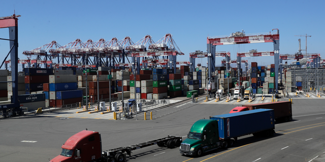 FILE- In this Aug. 22, 2018, file photo trucks travel along a loading dock at the Port of Long Beach in Long Beach, Calif. On Friday, Oct. 26, the Commerce Department issues the first of three estimates of how the U.S. economy performed in the third quarter. (AP Photo/Marcio Jose Sanchez, File)