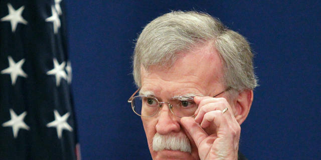 U.S. National security adviser John Bolton adjusts his glasses while speaking to the media during a news briefing following his meetings with Georgian officials in Tbilisi, Georgia, Friday, Oct. 26, 2018. (AP Photo/Shakh Aivazov)