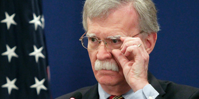 U.S. National security adviser John Bolton adjusts his glasses while speaking to the media during a news briefing following his meetings with Georgian officials in Tbilisi, Georgia, Friday, Oct. 26, 2018. (AP Photo/Shakh Aivazov)