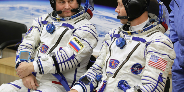 U.S. astronaut Nick Hague, right and Russian cosmonaut Alexey Ovchinin, member of the main crew of the expedition to the International Space Station (ISS), speak prior to the launch of Soyuz MS-10 space ship at the Russian leased Baikonur cosmodrome, Kazakhstan, Thursday, Oct. 11, 2018. (AP Photo/Dmitri Lovetsky)