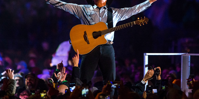 In an Oct. 20, 2018 file photo, Garth Brooks performs before a sold-out crowd at Notre Dame Stadium, in South Bend, Ind.