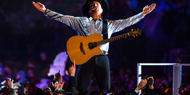 In an Oct. 20, 2018 file photo, Garth Brooks performs before a sold-out crowd at Notre Dame Stadium, in South Bend, Ind.