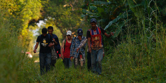 A small group of Honduran migrants trying to reach the U.S. border walk along train tracks in Trancas Viejas, Veracruz state, Wednesday, Oct. 24, 2018. As a caravan of thousands of Central Americans renewed their slow march toward the U.S. on Wednesday, others chose to travel in smaller groups following routes well-worn by decades of migrants fleeing poverty and violence.(AP Photo/Rebecca Blackwell)