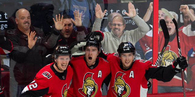 Ottawa Senators right wing Mark Stone celebrates his game-winning goal with teammates Thomas Chabot (72) and center Matt Duchene (95) during overtime of an NHL game in Ottawa, Ontario, Saturday, Oct. 20, 2018. A Senators player has tested positive for the coronavirus, according to a team statement Tuesday night. It's the first known case in the NHL so far.<br data-cke-eol="1">
(Adrian Wyld/The Canadian Press via AP)
