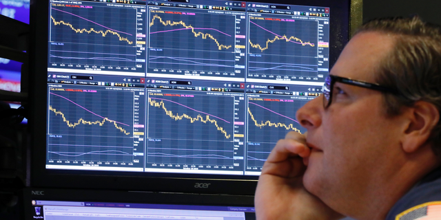 FILE- In this Oct. 10, 2018, file photo specialist Gregg Maloney works at his post on the floor of the New York Stock Exchange. The stock market has offered the best long-term returns historically, but they’ve come at a price. Stocks can drop suddenly, sometimes for inexplicable reasons. Drops of 10 percent are common enough, even when the market is largely on the upswing, that Wall Street has a term for them: “corrections.” Since the summer of 2015, the S&P 500 has had three such declines, and the index is one bad day away from a fourth. The S&P 500 is down TK percent since setting its record last month. (AP Photo/Richard Drew, File)
