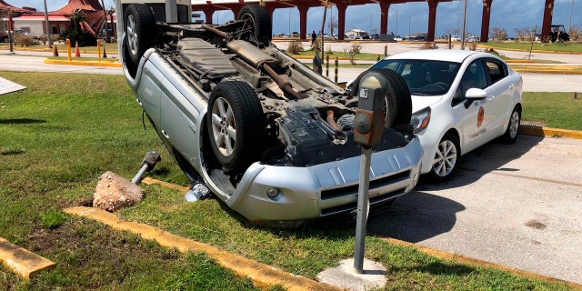 An overturned car is shown at the airport after Super Typhoon Yutu hit the U.S. Commonwealth of the Northern Mariana Islands, Friday, Oct. 26, 2018, in Garapan, Saipan. Residents of the U.S. territory are preparing for months without electricity or running water after the islands were slammed with the strongest storm on Thursday to hit any part of the U.S. this year. (AP Photo/Dean Sensui)