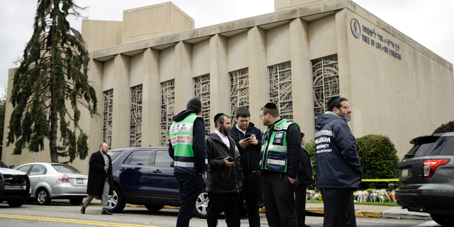 Personnel from Chesed Shel Emes Emergency Services and Recovery Unit gather near the Tree of Life Synagogue in Pittsburgh, Sunday, Oct. 28, 2018. Robert Bowers, the suspect in the mass shooting at the synagogue, expressed hatred of Jews during the rampage and told officers afterward that Jews were committing genocide and he wanted them all to die, according to charging documents made public Sunday. (AP Photo/Matt Rourke)