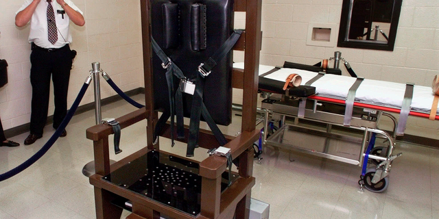 FILE - In this Oct. 13, 1999, file photo, Ricky Bell, the warden at Riverbend Maximum Security Institution in Nashville, Tenn., gives a tour of the prison's execution chamber. If Tennessee electrocutes Zagorski, it will be in an electric chair built by a self-taught execution expert who is no longer welcome in the prison system. (AP Photo/Mark Humphrey, File)