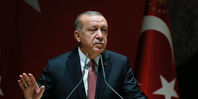 Turkey's President Recep Tayyip Erdogan talks to members of his ruling Justice and Development Party (AKP), in Ankara, Turkey, Friday, Oct. 26, 2018. The Saudi officials who killed journalist Jamal Khashoggi in their Istanbul consulate must reveal the location of his body, Erdogan said Friday in remarks that were sharply critical of the kingdom's handling of the case. (Presidential Press Service via AP, Pool)