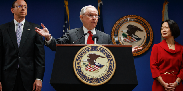Attorney General Jeff Sessions, joined by Deputy Attorney General Rod Rosenstein, left, and Jessie Liu, U.S. Attorney for the District of Columbia, right, speaks during a news conference at the U.S. Attorney's Office for the District of Columbia in Washington, Monday, Oct. 15, 2018, to announce on efforts to reduce transnational crime. (AP Photo/Carolyn Kaster)
