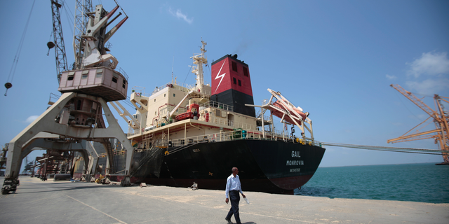 FILE - In this Saturday, Sept. 29, 2018, file photo, a cargo ship is docked at the port, in Hodeida, Yemen. Yemeni officials said Wednesday, Oct. 24, 2018 that the Saudi-led coalition has sent reinforcements to Yemen’s west coast ahead of a fresh assault on the rebel-held port city of Hodeida.(AP Photo/Hani Mohammed, File)