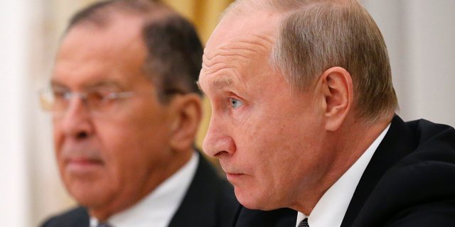Russian President Vladimir Putin listens to U.S. National security adviser John Bolton during their meeting in the Kremlin in Moscow, Russia, Tuesday, Oct. 23, 2018, with Russian Foreign Minister Sergey Lavrov at left. (AP Photo/Alexander Zemlianichenko)