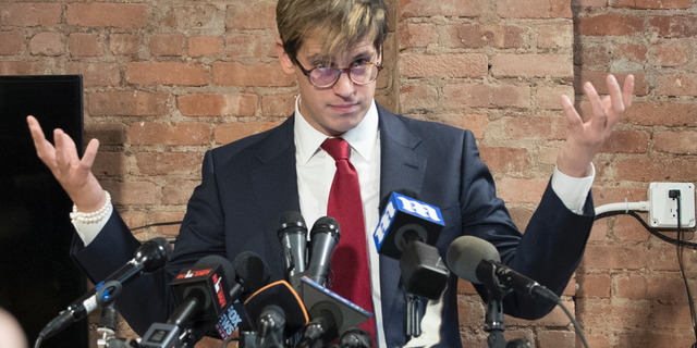 FILE- In this Feb. 21, 2017 file photo, Milo Yiannopoulos speaks during a news conference in New York. Citing safety concerns, New York University has postponed a speech by the right-wing provocateur that was scheduled for Halloween night, Wednesday, Oct. 31, 2018. (AP Photo/Mary Altaffer, File)