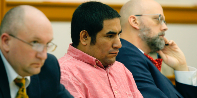 Zachary Koehn, center, is flanked by attorneys Les Blair III and Steven Drahozal, as he sits in court Tuesday, Oct. 30, 2018 in Mount Pleasant, Iowa. Assistant Iowa Attorney General Coleman McAllister told jurors Tuesday that Kohn's son, 4-month-old Sterling Koehn had been in the same diaper for nine to 14 days when his body was found in the swing Aug. 30, 2017. Koehn, is charged with murder and child endangerment. The boy's mother, Cheyanne Harris, is also charged and faces a separate trial at a later date. (Jeff Reinitz/The Courier via AP)